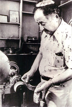A craftsman polishing a ram's horn shofar